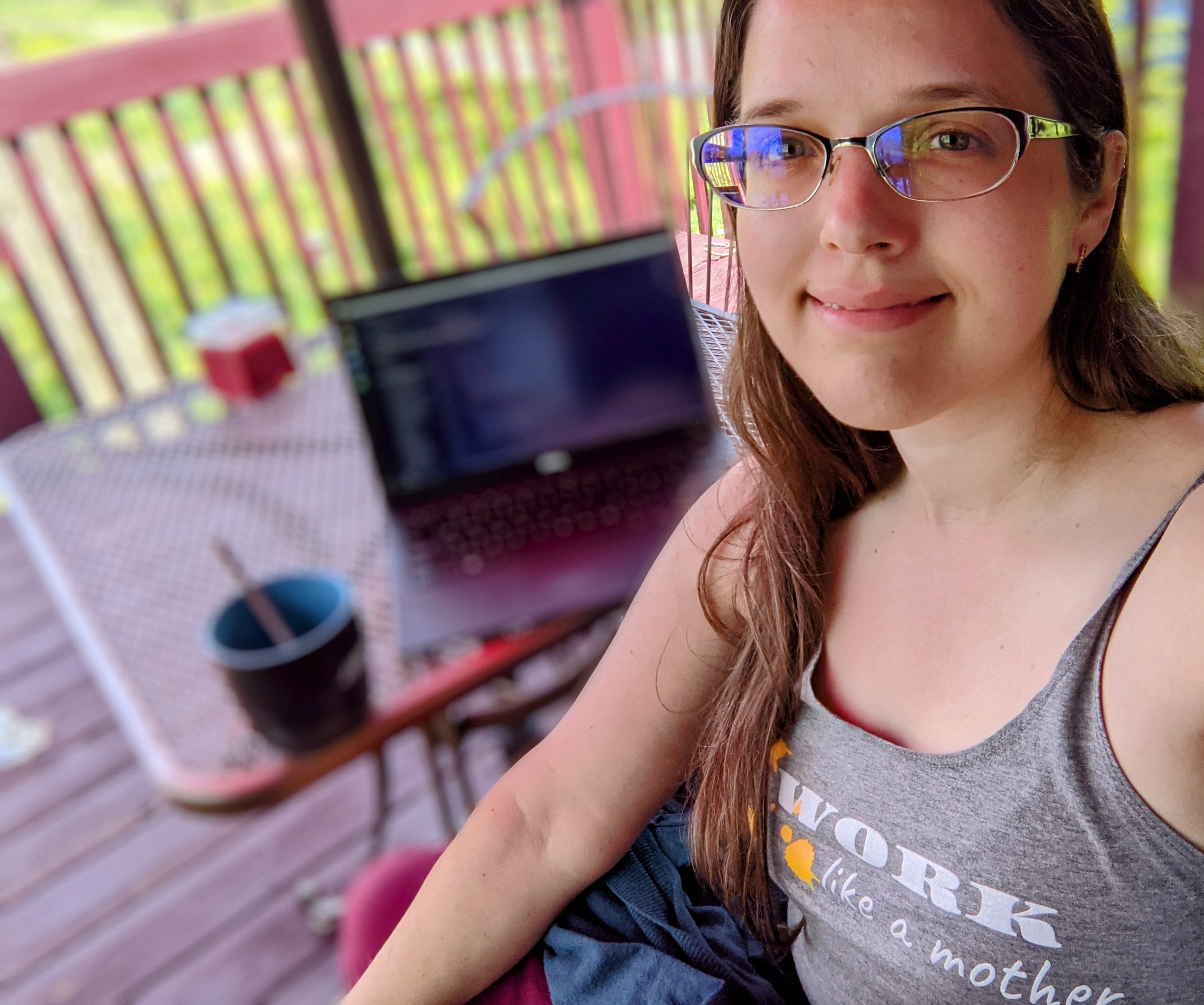 Aili in her outdoor office--a table on a balcony