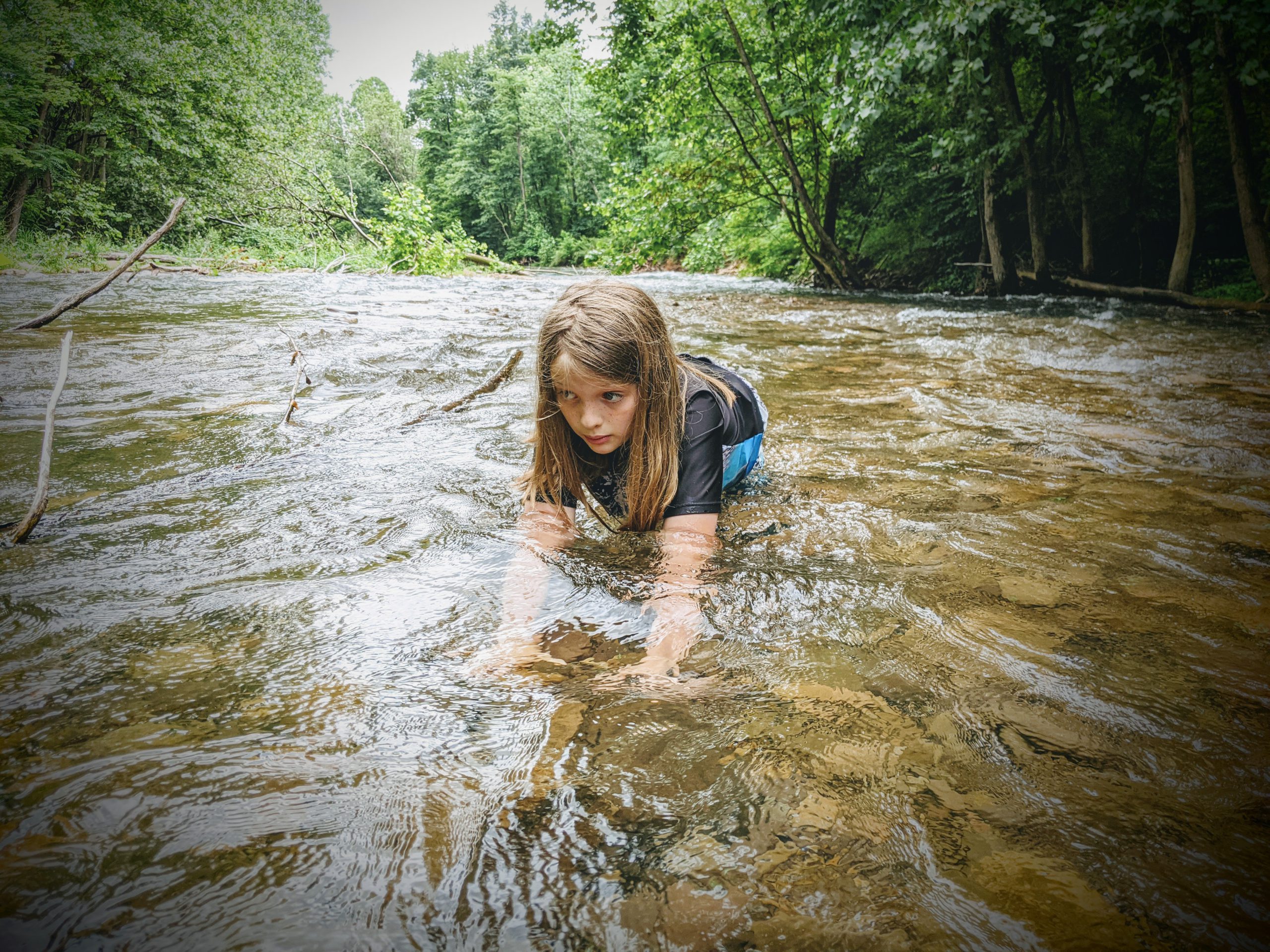 Silas kneeling in the river
