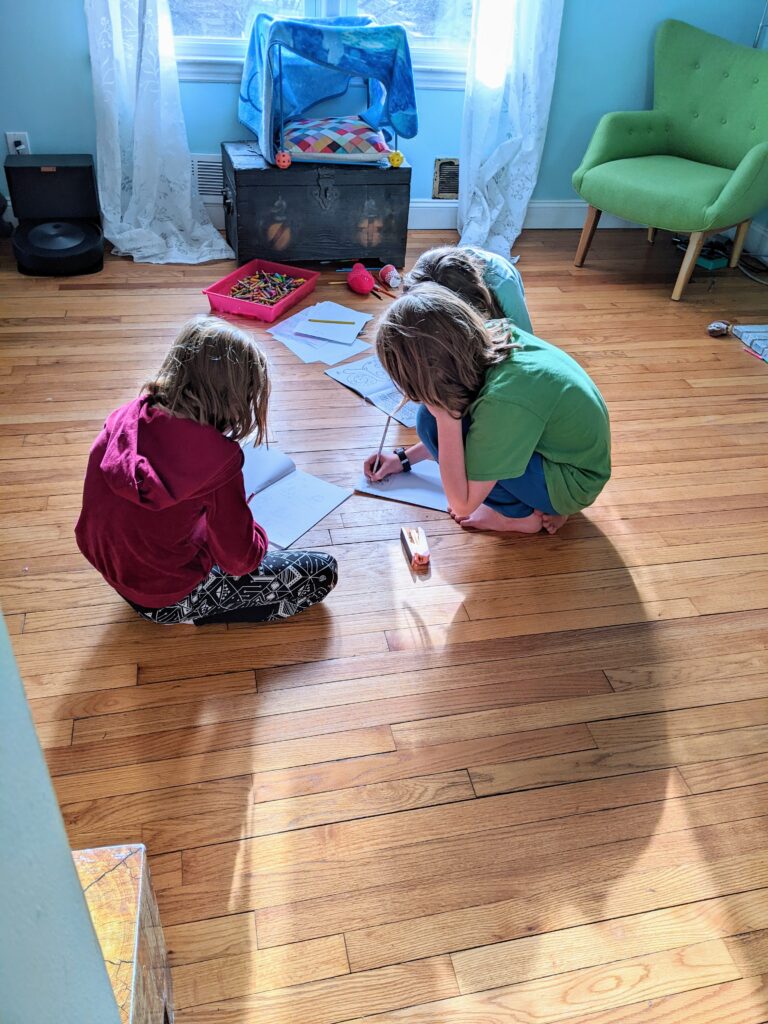 Beatrix, Silas, and Petra drawing together.