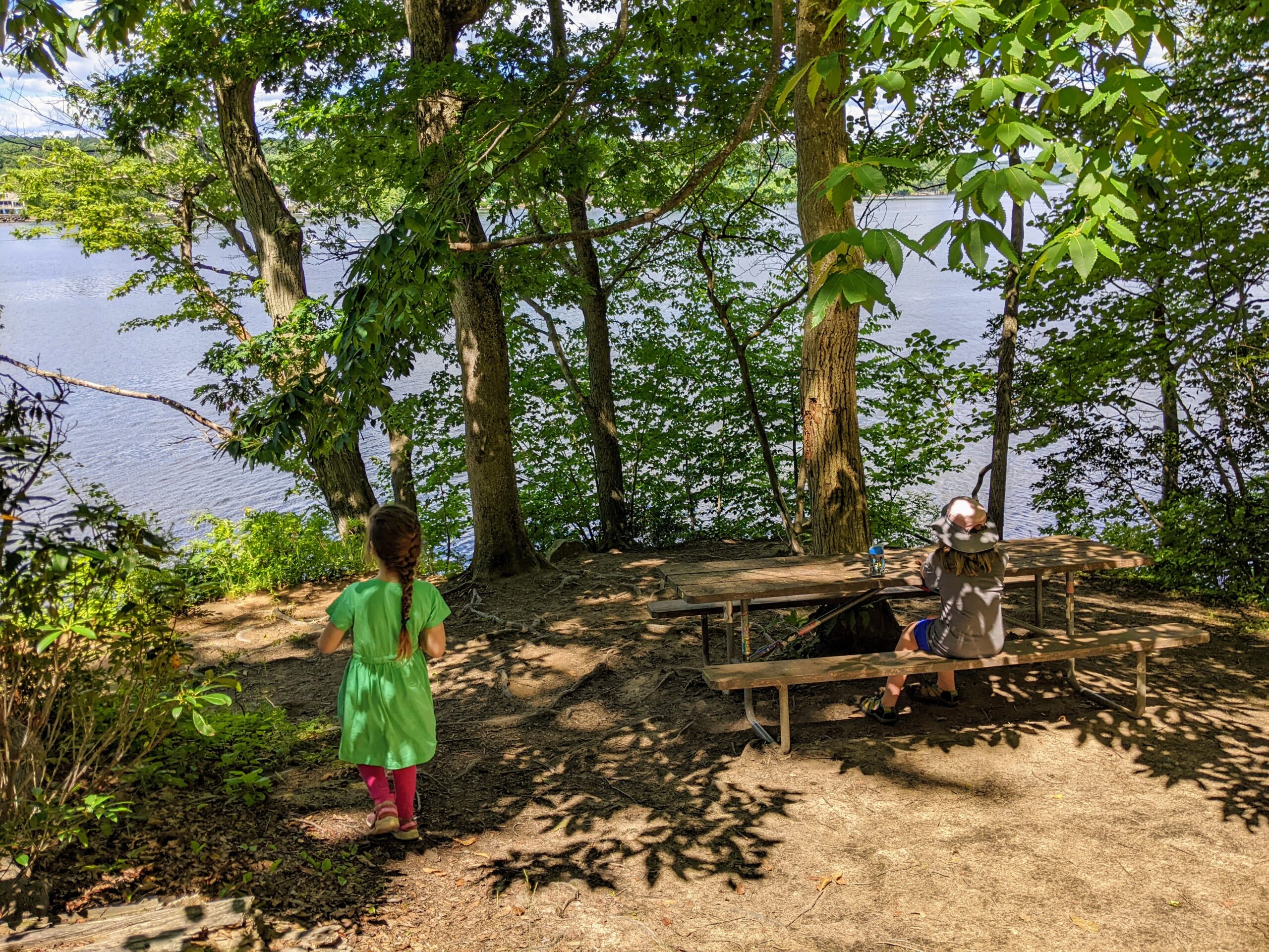 Kids taking a break on a hike, overlooking the river