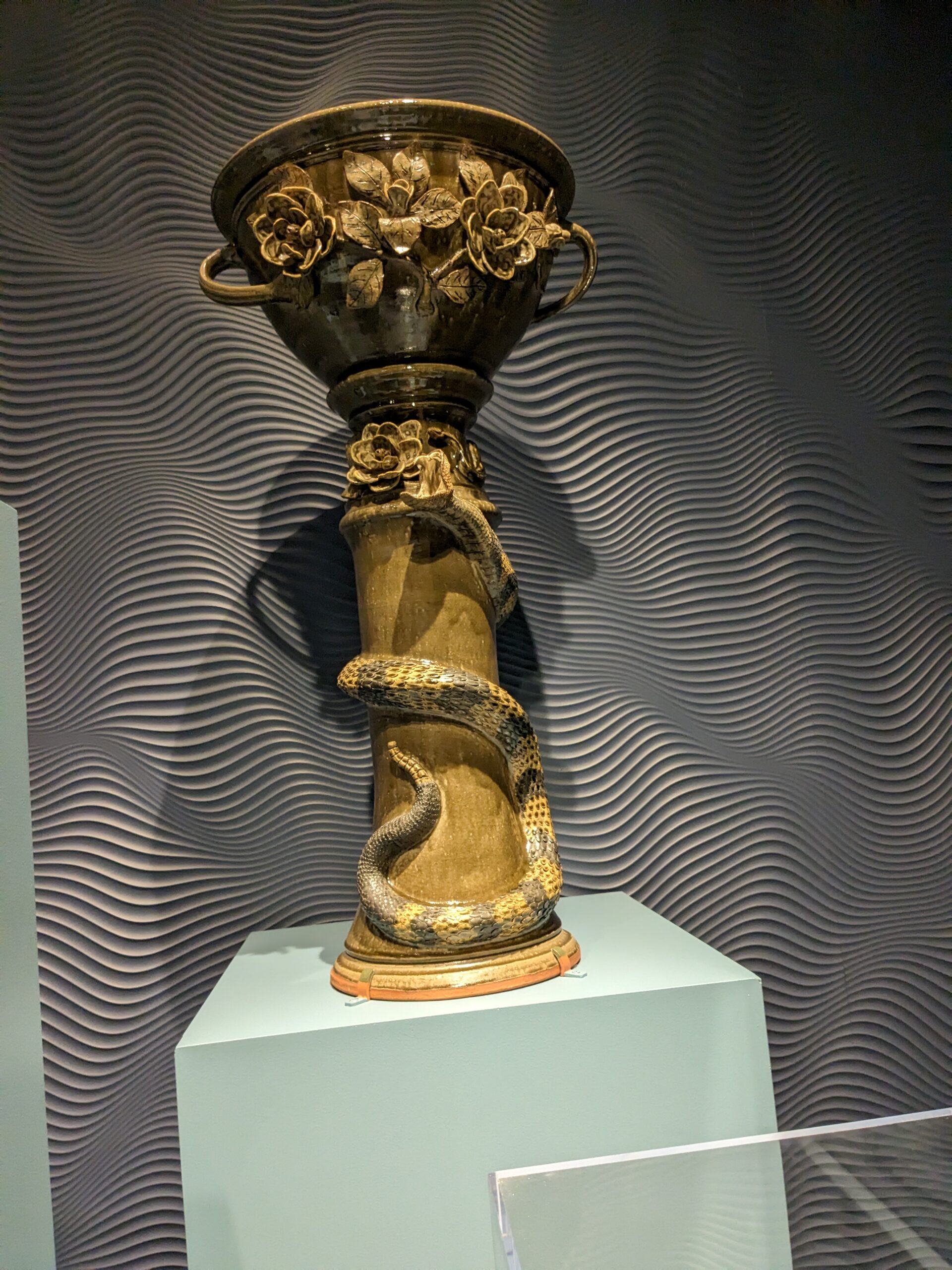 Weird pottery vase or chalice with a snake wrapping around it