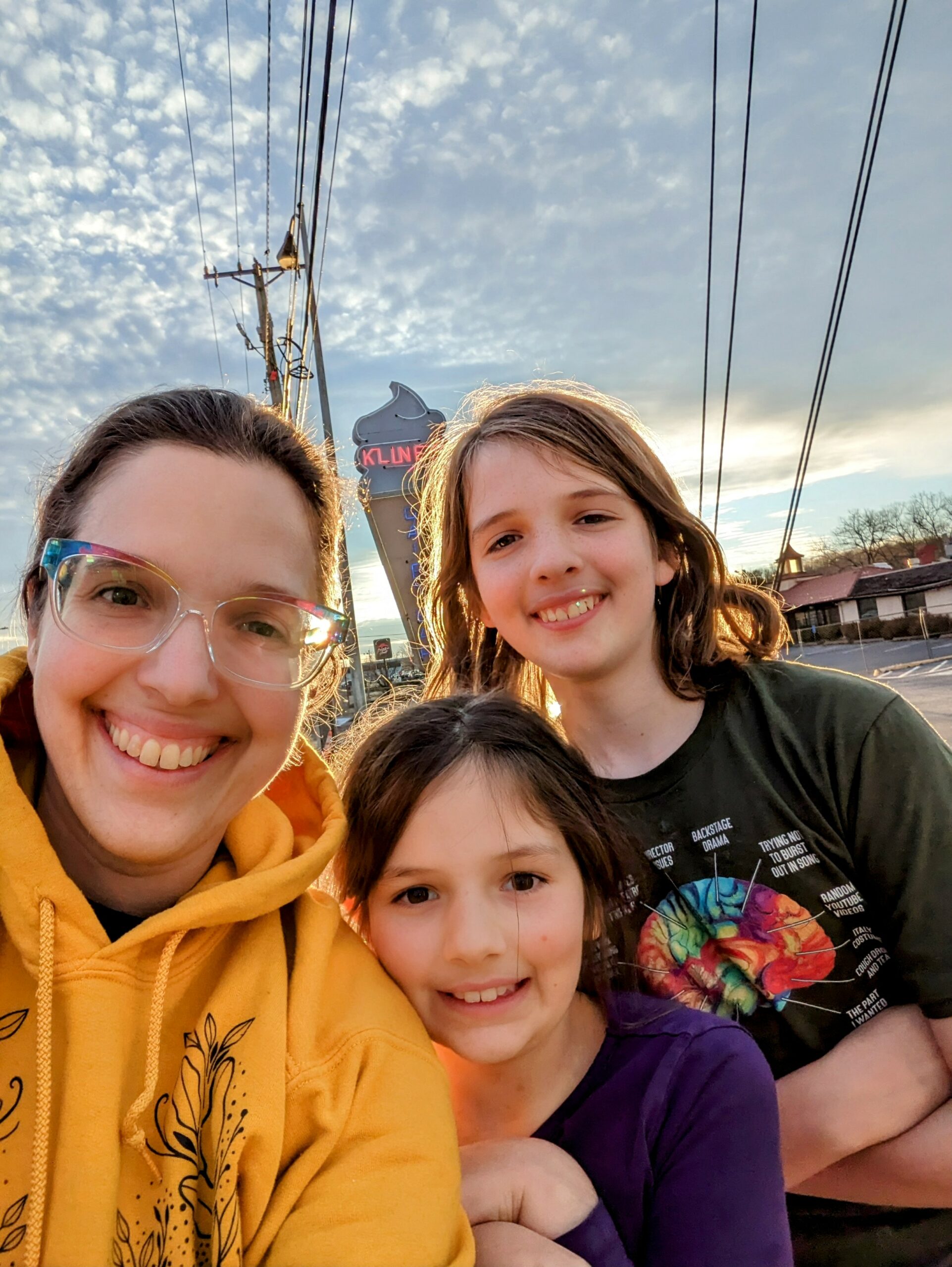Selfie - Aili, Petra, and Silas, with the Kline's ice cream cone sign behind.