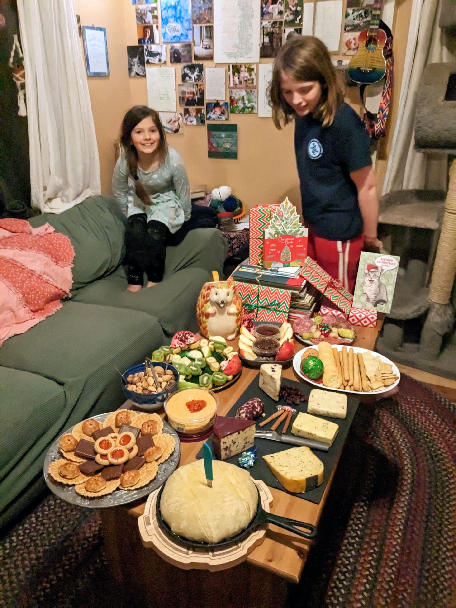 Petra looks on in pride as Silas ogles a table laden with charcuterie