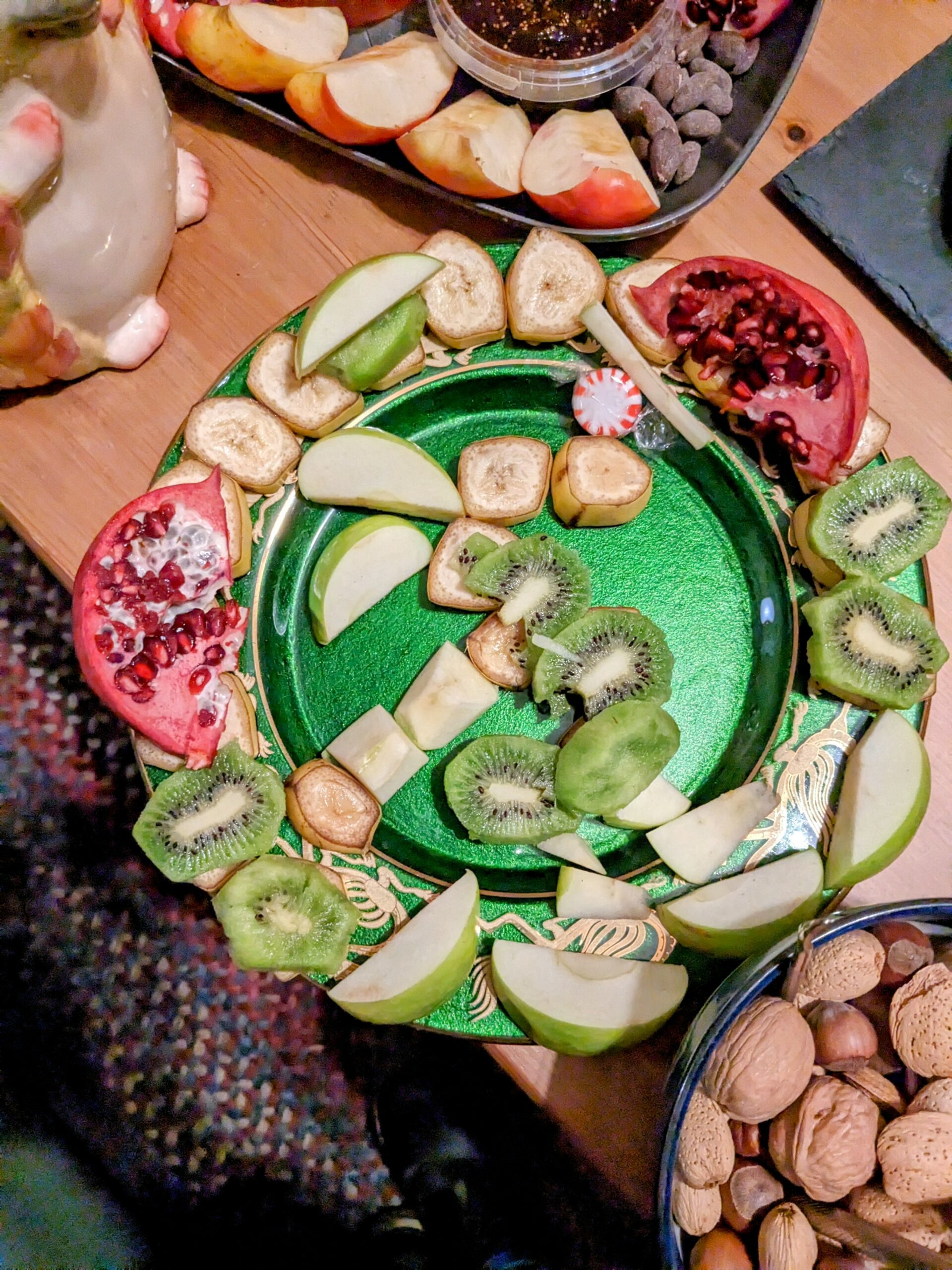 tight shot of a plate with a dragon made out of fruit.