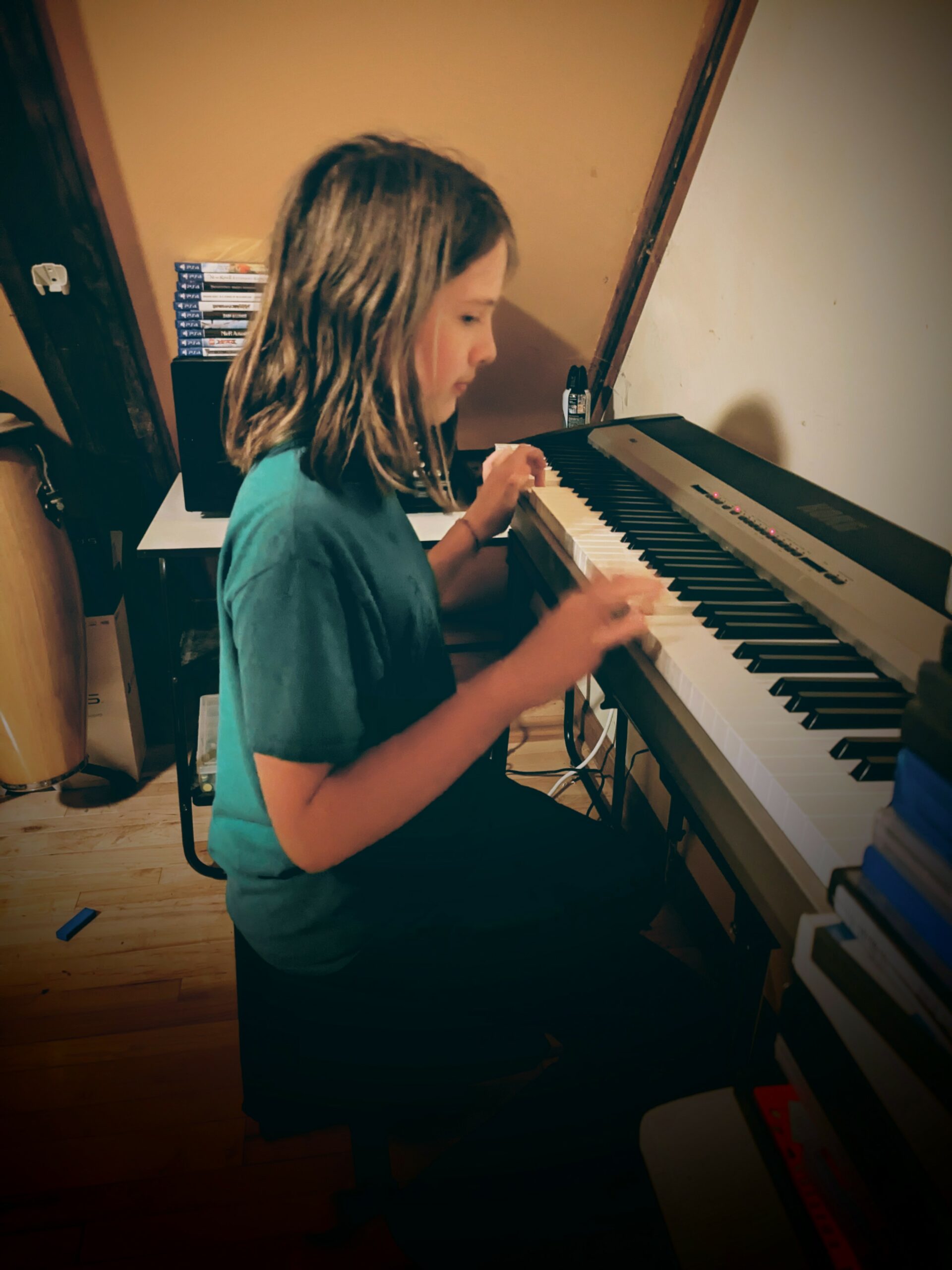 Silas, seated, playing his new keyboard.